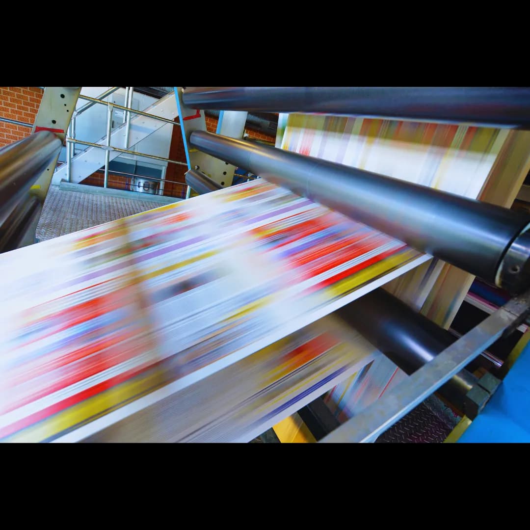 Assortment of high-quality printed marketing materials: flyers, tri-fold brochures, and postcards.